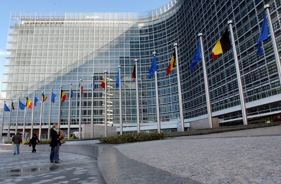 Belgian tricolor and European Union flags are seen on at the side entrance of the renovated Berlaymont Commission building in Brussels, Thursday Oct.21, 2004. EU Commission President Romano Prodi inaugurated the renovated Berlaymont building which will become the home of the European Union's head office after years of scandal and chaos surrounding the restoration. (AP Photo/Yves Logghe)