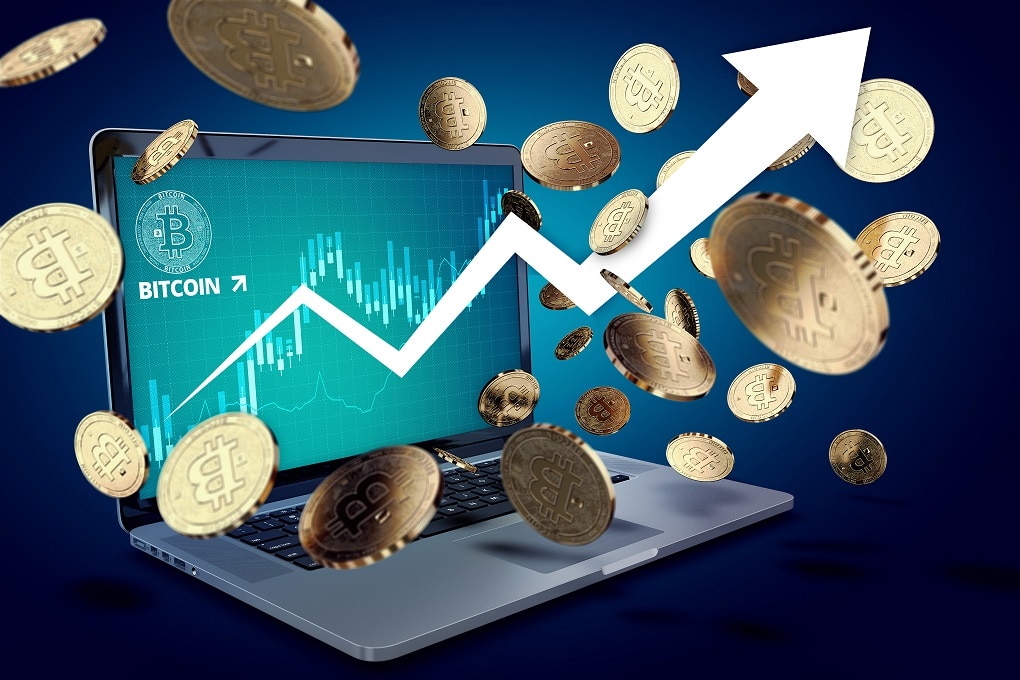 Floating Bitcoin coins against laptop with BTC success chart on-screen and arrow pointing up. Bitcoin heading "to the moon" concept. 3D illustration