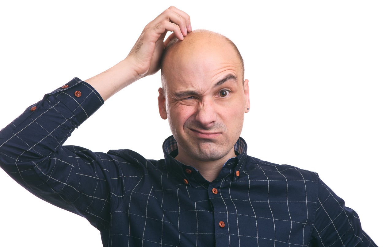 Confused bald guy scratch his head. Isolated on white