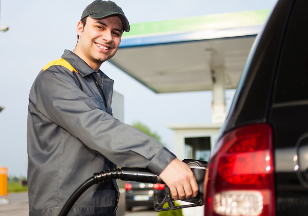 Smiling gas station attendant at work