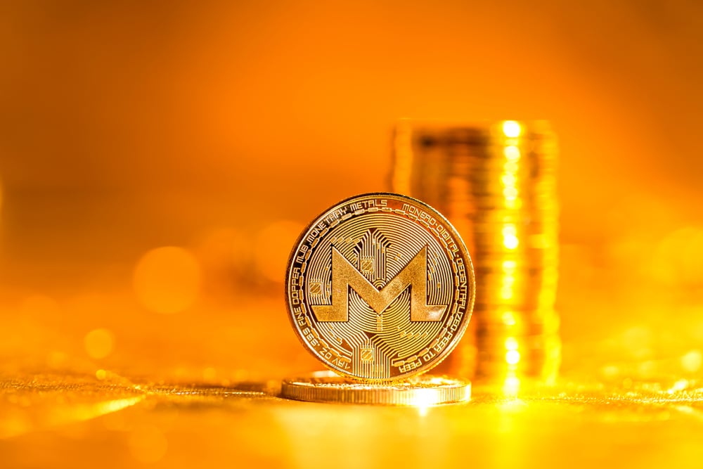 Monero cryptocurrency coin on a golden background