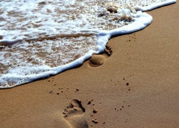 Huellas en la arena siendo borradas por el mar. Fuente: Thomas Gerlach /  Pixabay.com