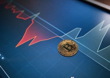 Moneda de Bitcoin sobre pantalla con gráfico alcista de mercado. Fuente: mstandret / elements.envato.com