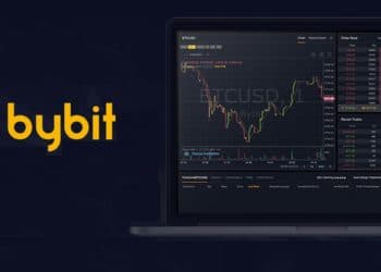 Logo del exchange Bybit junto a laptop