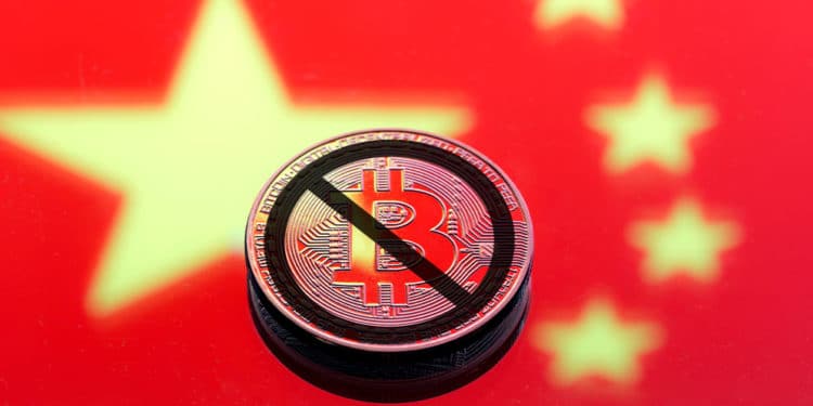 Bandera de China con bitcoin tachada como prohibida.