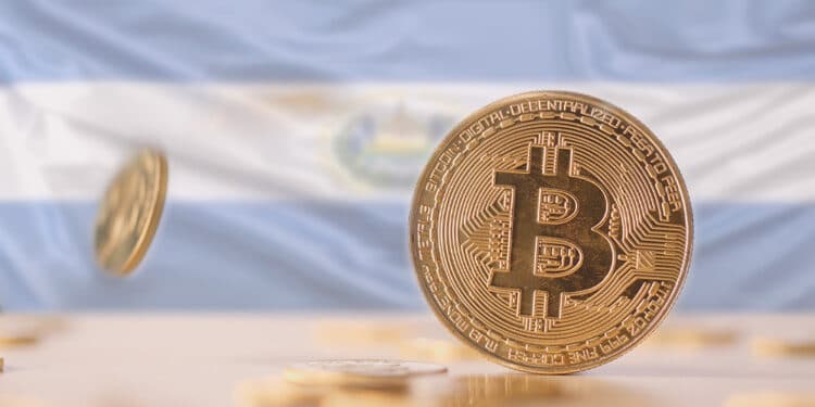 Bitcoins sobre mesa y bandera de El Salvador.
