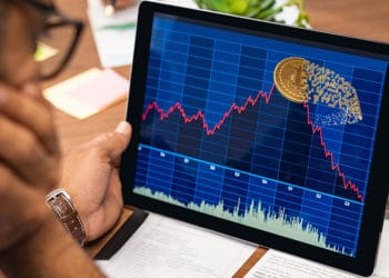 Persona y gráfico bursátil con bitcoin en la cima.