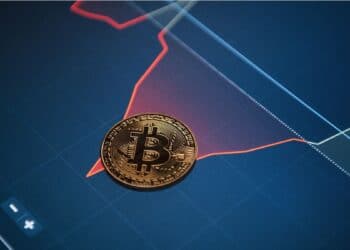 Moneda bitcoin sobre gráfico de variación de precio