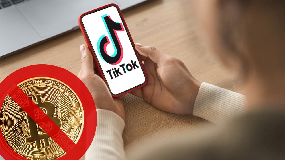 Teléfono con tik tok y btc con signo de prohibido.