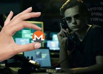 Hacker con códigos a un lado y mano sosteniendo Monero.