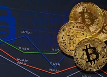 Monedas bitcoins sobre gráficas de precio