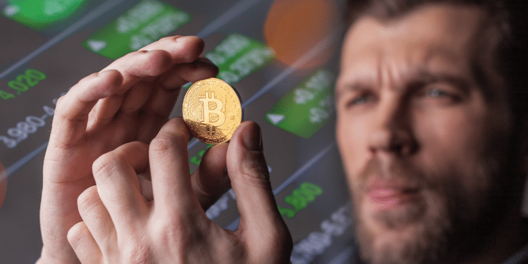 Persona deseando BTC con gráficos de fondo.