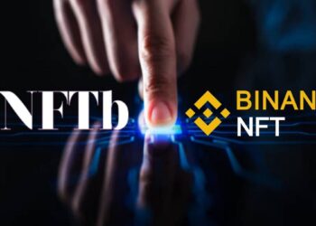 Logos de NFTb y Binance NFT sobre mano humana