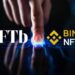 Logos de NFTb y Binance NFT sobre mano humana