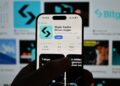 Manos sosteniendo un celular con la app de Bitget en pantalla.