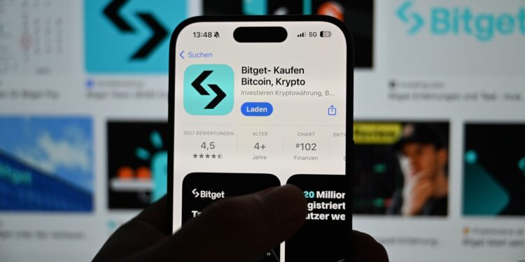 Manos sosteniendo un celular con la app de Bitget en pantalla.