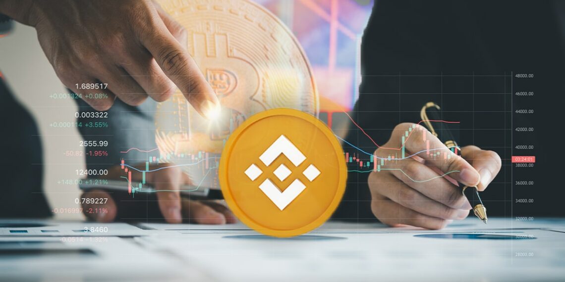 moneda de Binance en frende de gráficos y analistas de mercado con moneda de bitcoin difuminada en el fondo