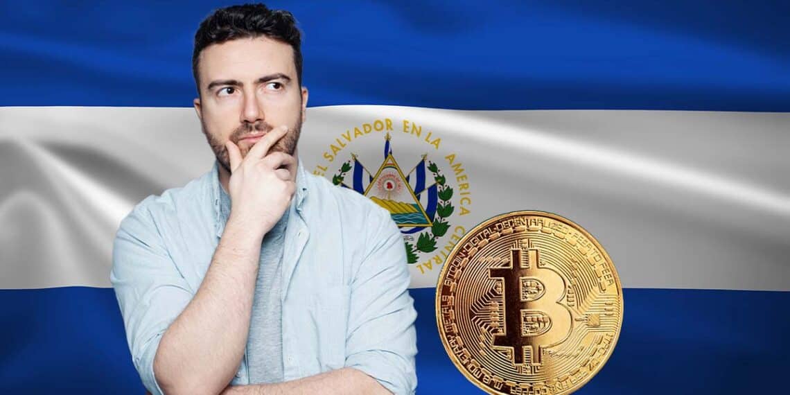 Hombre pensativo junto a un bitcoin y la bandera de El Salvador.