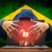 Hacker robando criptomonedas acompañado con a bandera de Brasil.