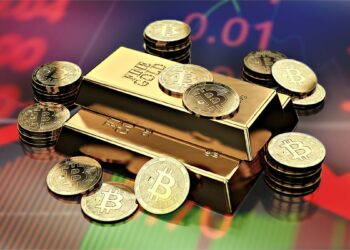 monedas de bitcoin sobre lingotes de oro en mesa con gráfico de crisis proyectado