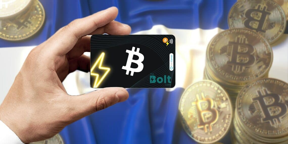 mano sostiene tarjeta bold con bitcoins sobre bandera de El Salvador en el fondo