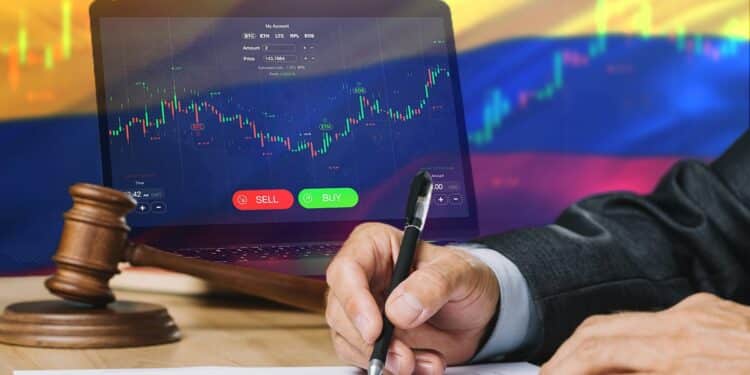 hombre revisa documento con computadora en plataforma de exchange y bandera de colombia en el fondo