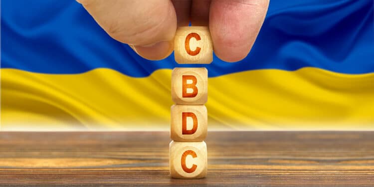 Cubos de madera con letras CBDC y fondo de bandera de Ucrania