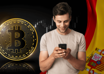 Joven junto a bitcoin y bandera de España.