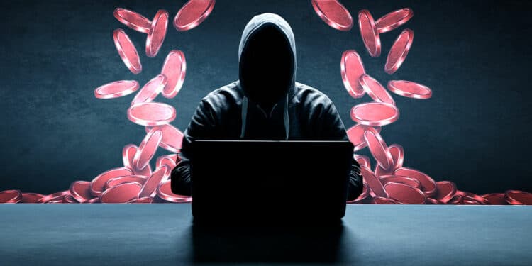 Estafador con laptop y tokens rojos
