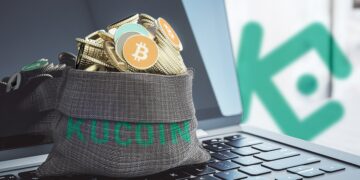 bolsa con logo de kucoin llena de criptomonedas sobre computadora con loo de kucoin en el fondo