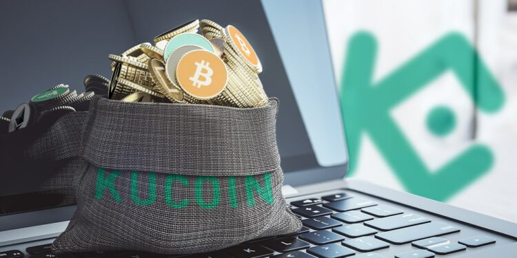 bolsa con logo de kucoin llena de criptomonedas sobre computadora con loo de kucoin en el fondo