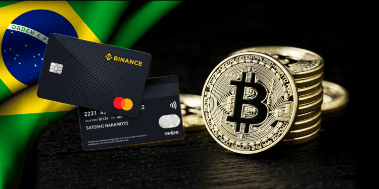 Tarjetas de binance y mastercard junto a bitcoin y bandera de Brasil.