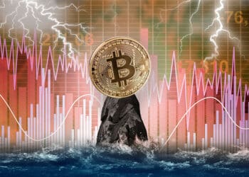 Bitcoin sobre un risco en el mar y graficos rojos