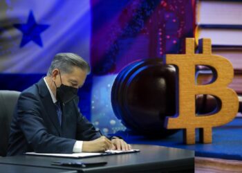 presidente de Panamá, Laurentino Cortizo, firmando documentos con bandera de Panamá en el fondo junto a logo de Bitcoin y martillo de leyes