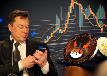 Elon Musk revisando telefonod movil con logos de twitter alrededro con moneda de Floki sobre superficie con graficos de mercado
