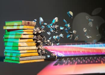 libros con logo de Bitcoin desintegrandose con laptop y logo de apple en el fondo