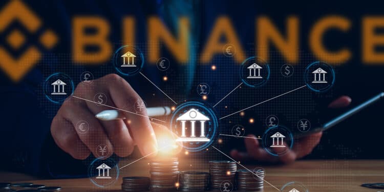 personas apilando monedas con bancos digitales conectados en red y logo de binance en el fondo