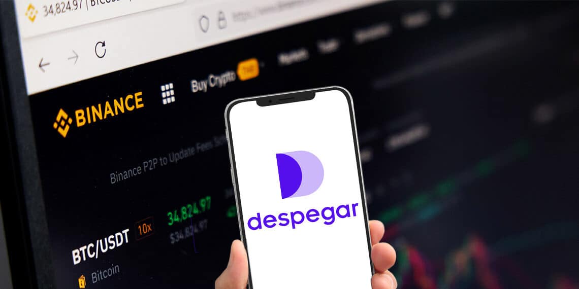 Celular con aplicación de despegar junto a plataforma de binance.