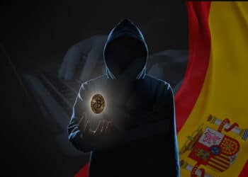 Hacker con bitcoin y bandera de España.