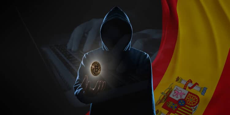 Hacker con bitcoin y bandera de España.