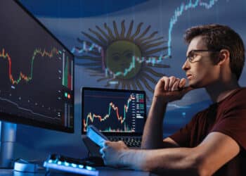 trader estudiando graficos de precio en pantallas de computadora con bandera de Argentina y grafico de precio en el fondo