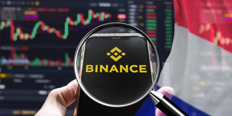 Una lupa apuntando al logo del exchange Binance y bandera de Francia.