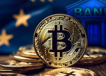 monedas de bitcoin sobre mesa con bandera de europa y edificación de bitcoin en el fondo