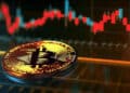 moneda de bitcoin sobre plataforma digital con grafico de precio en el fondo