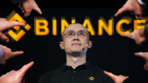 manos señalando a Changpeng Zhao, CEO de Binance con logo de la empresa detrás