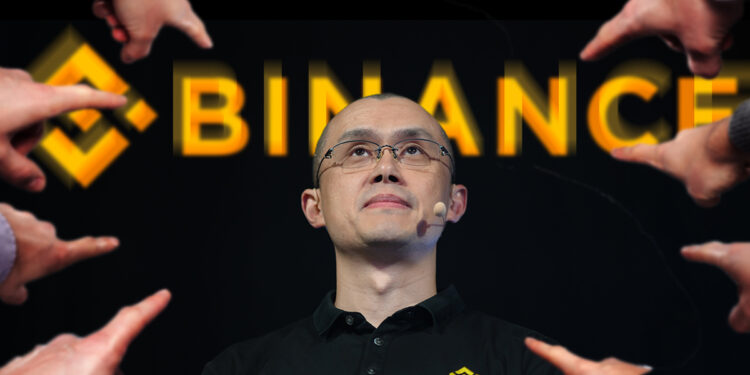 manos señalando a Changpeng Zhao con logo de binance en el fondo