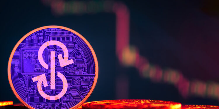 moneda de yarns finance con grafico bajhista en rojo al fondo