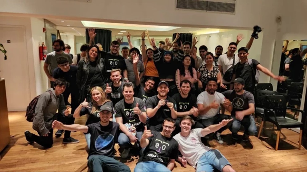 Grupo de jovenes reunidos saludando, asistentes a la segunda edición de la criptoconferencia en Argentina.