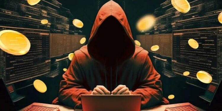 Hacker frente a una computadora y monedas en el aire rodeándolo