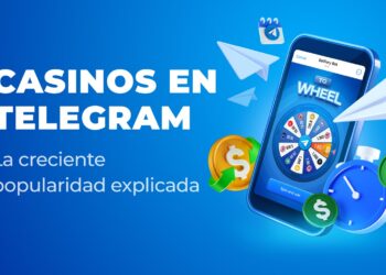 Telefono celular con una ruleta en pantalla y logos de Telegram volando alrededor.